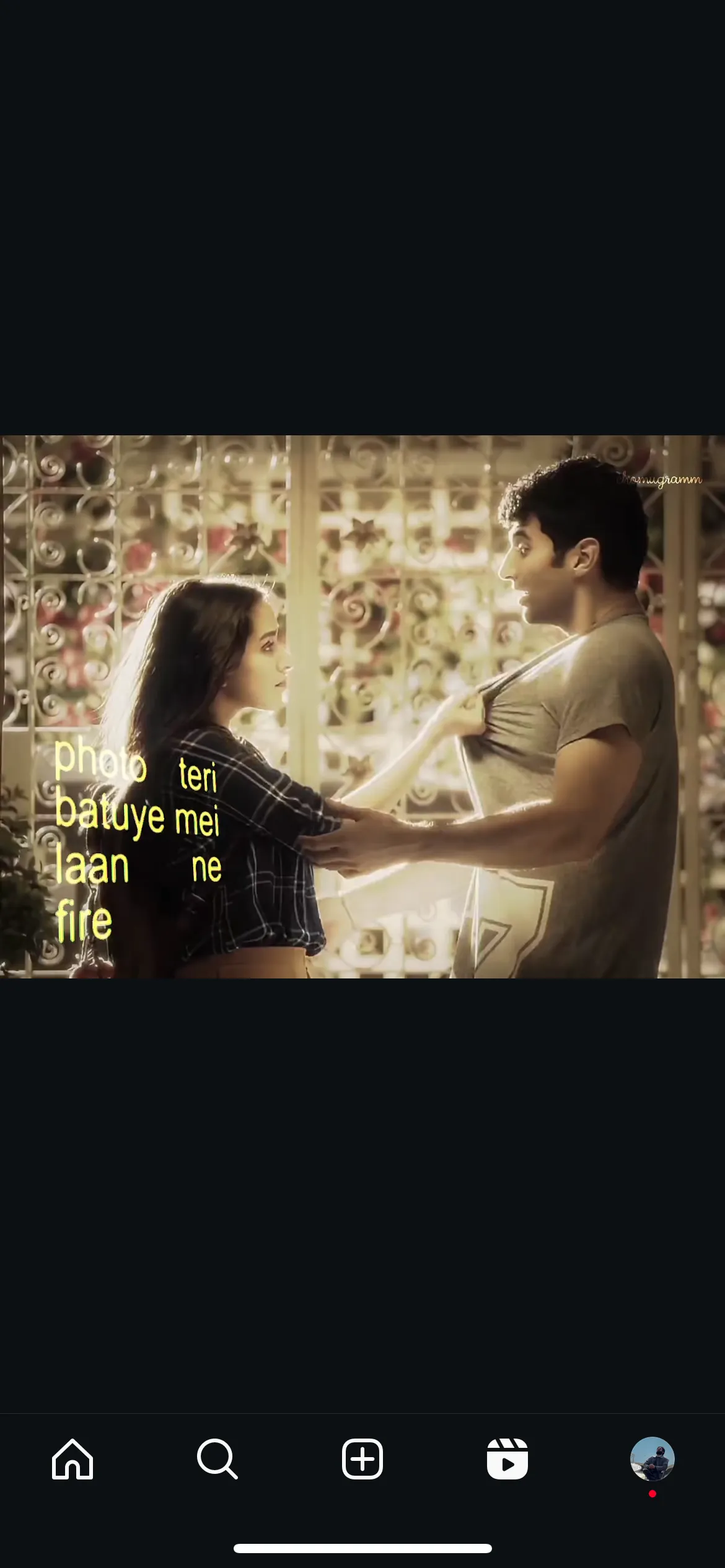 Screenshot of a reel: a couple in a romantic Hindi film scene, overlaid with yellow Hindi lyric text