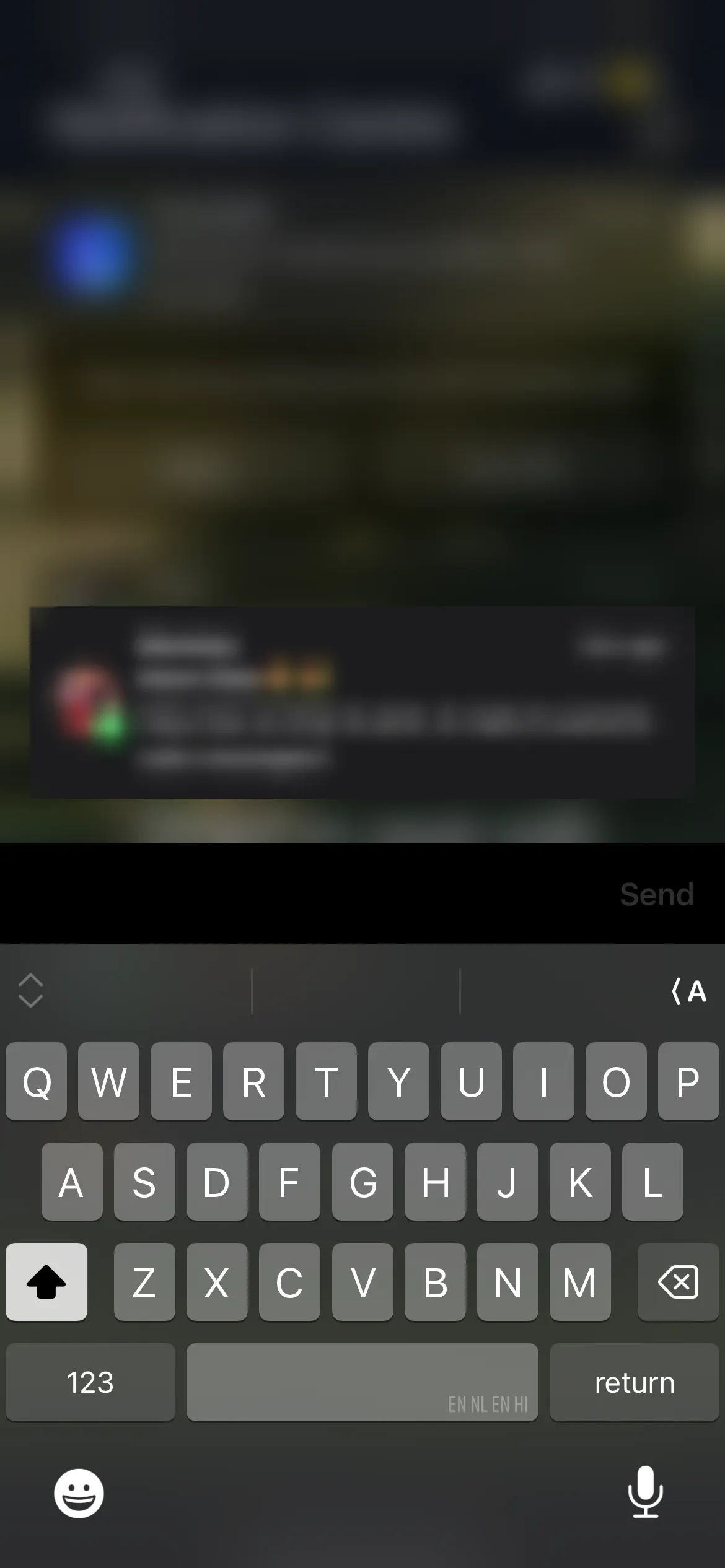 Screenshot of a phone keyboard with a blurred message notification above it