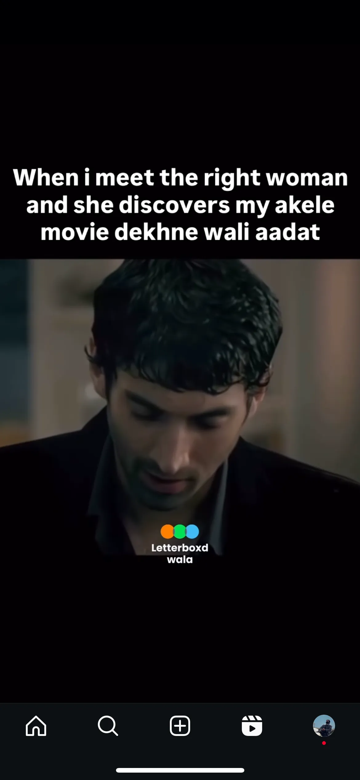 Screenshot of a reel: a man looking down in a dim film scene, captioned: When i meet the right woman and she discovers my akele movie dekhne wali aadat
